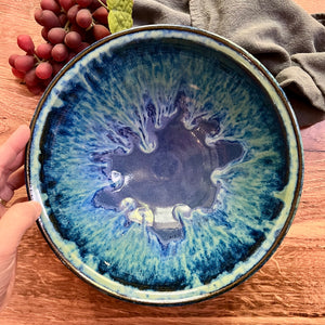  large "Blue World" serving bowl. wheelthrown, trimmed and glazed by Artist, Meredith Chernick. the bowl is glazed in cobalt blue with turquoise green glaze melting down into the blue from the rim of the bowl. No two are ever the same, each with unique drip patterns Approximtely 9" in Diameter