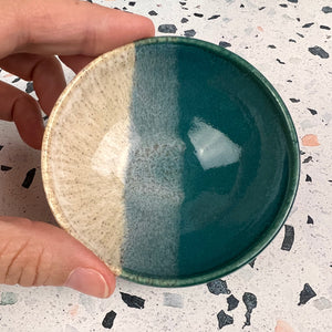 Tiny bowl, sauce bowl, ring dish. Wheel thrown on the potters wheel and glazed in teal and speckled white glaze with an overlap of colors in the center. 
