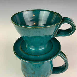 Coffee pour over with finger loop handle, shown on top of a matching mug.  wheel-thrown pottery, Teal glaze on red clay. Fern Street Pottery