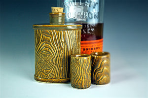 matching lumberjack flask and shot glasses. shown with bourbon in background. Fern Street Pottery.
