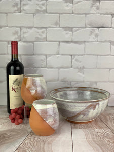 Artisan crafted serving bowls in a rustic Speckled White glaze shown with wine tumblers. bowl shown is 9" in diameter