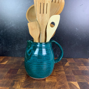 Teal pottery pitcher, shown here being used as a utensil holder