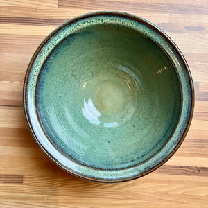 large "Mottled Green" serving bowl. wheelthrown, trimmed and glazed by Artist, Meredith Chernick. the bowl is glazed in a rich mottled green glaze that shows the beautiful red clay through the edges.. No two are ever the same, each with unique glaze patterns