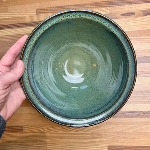 large "Mottled Green" serving bowl. wheelthrown, trimmed and glazed by Artist, Meredith Chernick. the bowl is glazed in a rich mottled green glaze that shows the beautiful red clay through the edges.. No two are ever the same, each with unique glaze patterns