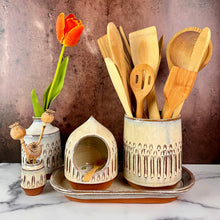 Load image into Gallery viewer, utensil holder, wheel thrown stoneware, handcarved texture. red clay with speckled white glaze shown here with matching kitchen peices: salt cellar, tray and bud vases