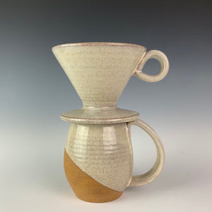 showing one mug and pour over from the coffee gift set including two angle dipped coffee mugs, one coffee pour over and a matching bud vase. handcrafted, wheel thrown stoneware pottery