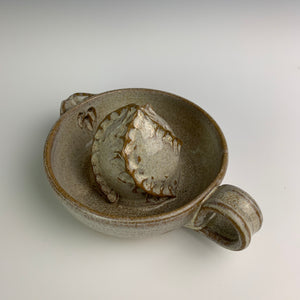 Pottery Citrus juicer, thrown on the wheel in red clay, glazed in speckled white. pulled handle, pouring spout and seed straining holes.