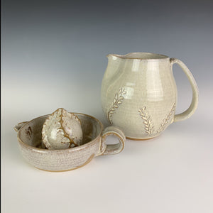 Pottery Citrus juicer, thrown on the wheel in red clay, glazed in speckled white. shown with matching pitcher with carved detail.