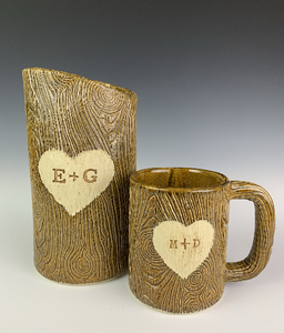 customized version of lumberjack vase and mug with initials and heart carved into woodgrain texture. Fern Street Pottery.