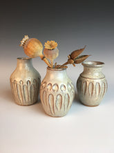 Load image into Gallery viewer, Three different but matching bed vases. tiny pottery vases thrown on the potter&#39;s wheel in red clay, carved, then glazed in white. shown with dried flowers