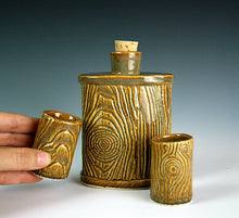 Load image into Gallery viewer, lumberjack flask shown with matching shot glasses, pottery carved to look like woodgrain