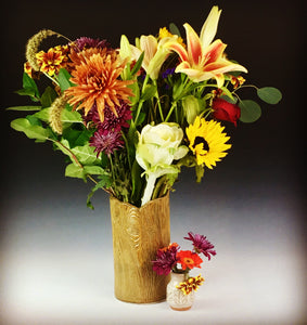 2" bud vase shown with daisies and a lager woodgrain vase