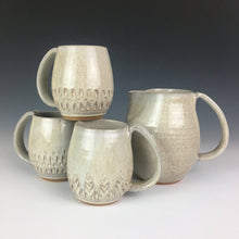Load image into Gallery viewer, pitcher in speckled white shown with various carved mugs.