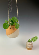 Load image into Gallery viewer, Carved bud vase shown here with matching hanging planter. red clay, white glaze