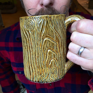 northwest woodsman drinking out of a lumberjack style mug