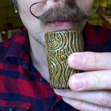 Load image into Gallery viewer, mustachioed man with handlebar mustache drinking from a lumberjack shot glass. pottery shot glass carved to look like wood