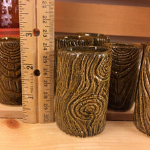 Load image into Gallery viewer, woodgrain carved lumberjack shot glass with ruler for reference. 2.5 &quot; tall