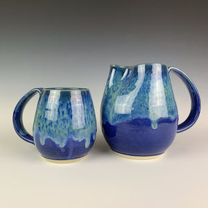 Pitcher and mug shown together. shown in blue world glaze. wheel thrown artisan pottery by meredith at Fern Street Pottery