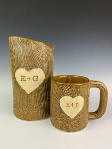 lumberjack, woodgrain appearance on pottery mug and vase. with heart and initials custom carved into surface