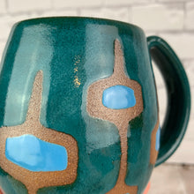Load image into Gallery viewer, MidMod Mugs Freshly made with vintage inspired design and color. teal, white, turquoise, round square pattern. close up photo showing how the clay body is revealed through the glaze resist pattern. Fern Street Pottery