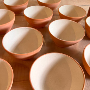 A batch of bowls, glazed but not yet fired, with insides glazed using the Glaze Splash Glaze Fountain kit from Fern Street Pottery