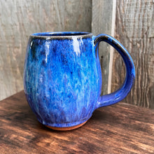 Load image into Gallery viewer, Blue World mug, blue glaze with melty turquoise blue and green glaze over a red stoneware clay. each one is different. northwest style coffee mug thrown pottery, with large pulled handle.