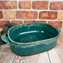 Load image into Gallery viewer, Casserole dish in Teal glaze with Iced rim. wheel thrown and altered, with pulled handles added. made with stoneware clay.