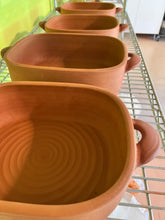 Load image into Gallery viewer, Casserole dish, several drying after being made, before the firing. wheel thrown and altered, with pulled handles added. made with stoneware clay.