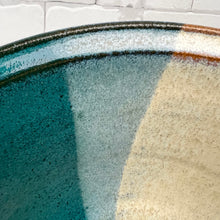 Load image into Gallery viewer, 9&quot; serving bowl, detail shot of the rim. this bowl is glazed half in teal, and half in white, with an overlay where the glazes meet.