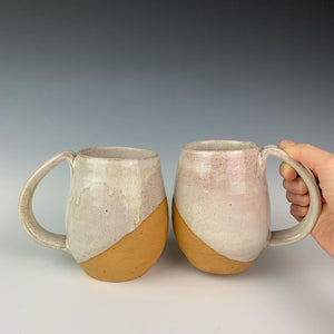 Showing two mugs from the coffee gift set including two angle dipped coffee mugs, one coffee pour over and a matching bud vase. handcrafted, wheel thrown stoneware pottery