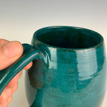 Load image into Gallery viewer, Closeup Angle patterned glaze on Hand crafted, wheel thrown pottery mugs. made on the potters wheel in red stoneware clay, glazed in speckled white or teal green glossy glaze. mugs have a pulled handle that fits full finger grip for most, with thumb groove. Fern Street Pottery. Angle dipped mug.