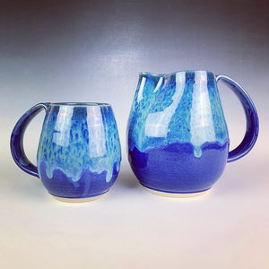 Blue world mug, northwest style coffee mug thrown pottery, with large pulled handle. shown here with matching pitcher