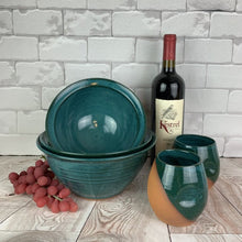 Load image into Gallery viewer, serving bowls in Teal glazed shown with wine tumblers. bowls are 7&quot;, 8&quot;, and 9&quot; in diameter. Large, wheel thrown serving bowl. Thrown in a deep red stoneware and glazed in rich teal