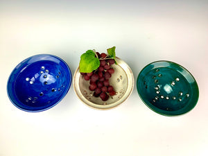 berry colanders, shown in Cobalt Blue, speckled white and teal. shown for rinsing berries or grapes