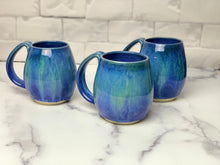 Load image into Gallery viewer, Blue World mugs, blue glaze with melty turquoise blue and green glaze. each one is different. northwest style coffee mug thrown pottery, with large pulled handle. 