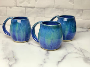 Blue World mugs, blue glaze with melty turquoise blue and green glaze. each one is different. northwest style coffee mug thrown pottery, with large pulled handle. 