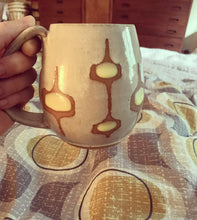 Load image into Gallery viewer, MidMod Mugs Freshly made with vintage inspired design and color. shown in white with yellow and orange clay round square pattern. shown with MidMod style fabric and Danish mid century furniture. Fern Street Pottery