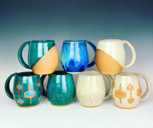 Load image into Gallery viewer, an array of mugs made by Meredith of Fern Street Pottery studio. mugs shown: angle dipped teal, blue world, angle dipped white, MidMod Teal, Tree carved teal, tree carved white, MidMod white and orange.