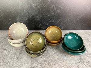 Sauce bowls for soy, hot sauce. shown here in a variety of colors. wheelthrown pottery bowls made of stoneware. Tea bag holders, ring holders. made at Fern Street Pottery