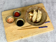 Load image into Gallery viewer, Sauce bowls for soy, hot sauce, shown with pot stickers. wheelthrown pottery bowls made of stoneware. Tea bag holders, ring holders. made at Fern Street Pottery
