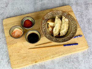 Sauce bowls for soy, hot sauce, shown with pot stickers. wheelthrown pottery bowls made of stoneware. Tea bag holders, ring holders. made at Fern Street Pottery