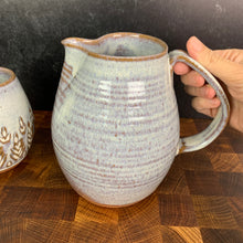 Load image into Gallery viewer, wheel thrown pottery pitcher shown in rustic white with pulled handle. handcrafted and wheel thrown at  Fern Street Pottery