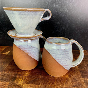 Showing two mugs from the coffee gift set including two angle dipped coffee mugs, one coffee pour over and a matching bud vase. handcrafted, wheel thrown stoneware pottery