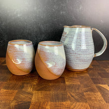 Load image into Gallery viewer, two pottery  tumblers with finger divots, shown here with a matching pitcher