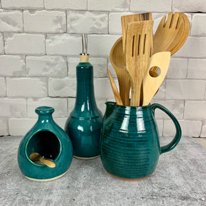 Pottery pitcher shown in teal with matching salt cellar, and oil cruet. pitcher can be used as a pitcher, utensil holder, or vase.
