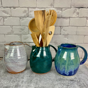 pottery pitchers, wheel thrown with pulled handles. shown in Rustic white, teal, and blue world. shown as utensil holder as well.
