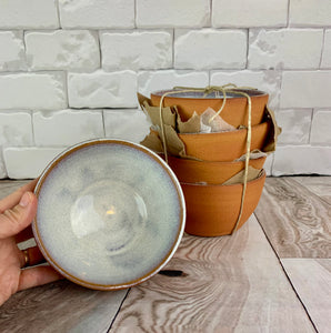 Showing one bowl interior glazed, exterior unglazed stoneware.(comes in a set of four.)   These bowls are glazed with a speckled, rustic white glaze inside and feature the red-brown exposed stoneware clay on the exterior.