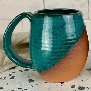 angle dipped mug glazed in Teal over red stoneware clay. Fern Street Pottery. Angle dipped mug.