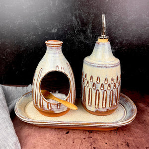 Salt cellar and Oil Cruet set with matching tray shown together here.  Made in  a red stoneware clay, carved and glazed in a speckled white glaze.