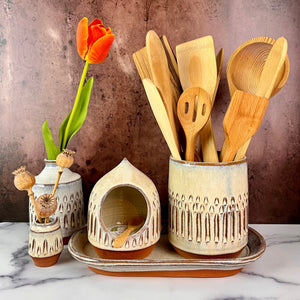 utensil holder, wheel thrown stoneware, handcarved texture. red clay with speckled white glaze shown here with matching kitchen peices: salt cellar, tray and bud vases
